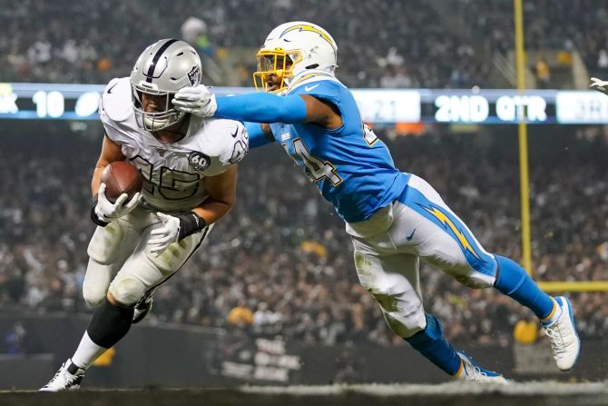 Oakland Raiders running back Alec Ingold (45) scores a touchdown against Los Angeles Chargers outside linebacker Kyzir White (44) during the second quarter on November 7 in Oakland, California.