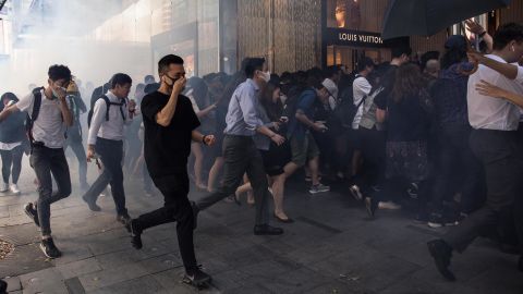 People run into a mall after police fired tear gas in the Central district of Hong Kong on November 11. 