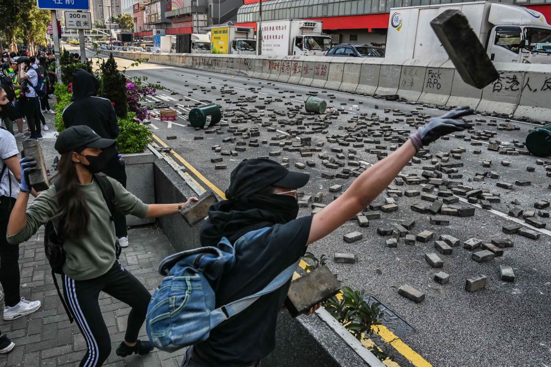 Protesters throw bricks in Wong Tai Sin district on November 11. 