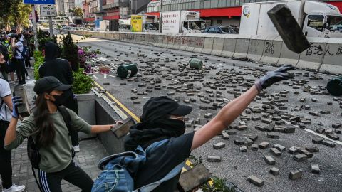 Protesters throw bricks in Wong Tai Sin district on November 11. 