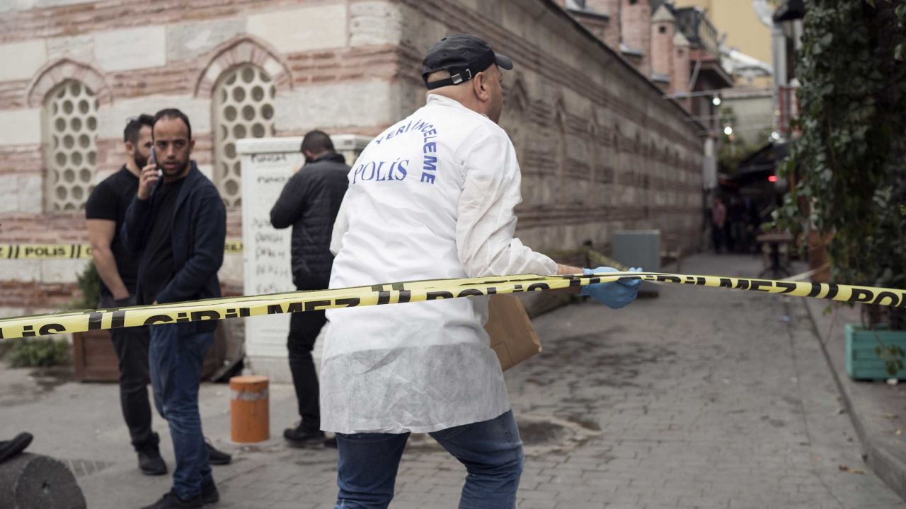 Police officers investigate at the scene of Le Mesurier's death.