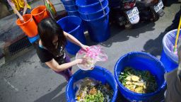 TAIPEI, TAIWAN - 2016/05/02: Residents of a Taipei community sort food waste into large blue containers for disposal by the city garbage collectors. Different trucks are used for garbage, recyclables and food waste. Since the government initiated the garbage sorting program in the late 1990's, Taipei's recycling rate has grown to 67%.. (Photo by Craig Ferguson/LightRocket via Getty Images)