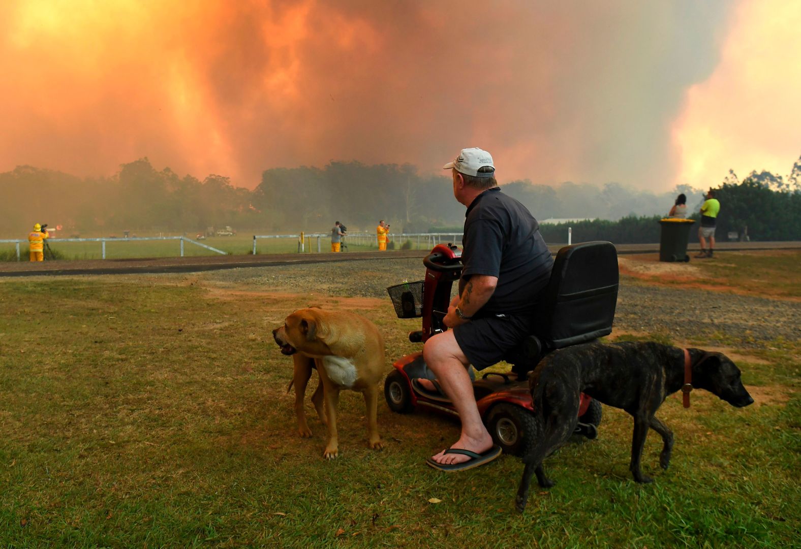 Locals watch the fires impact farmland near Nana Glen on November 12.