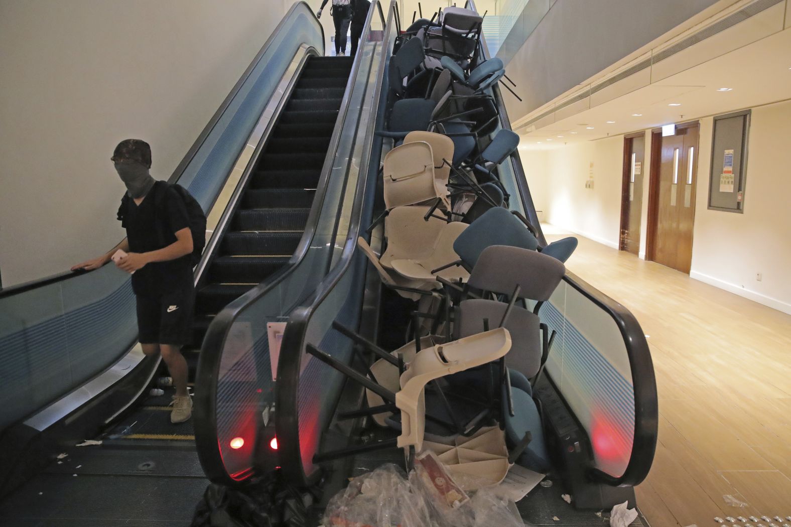 Students block an escalator with chairs in an attempt to hamper police at the University of Hong Kong on November 12.