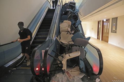 Students block an escalator with chairs in an attempt to hamper police at the University of Hong Kong on November 12.