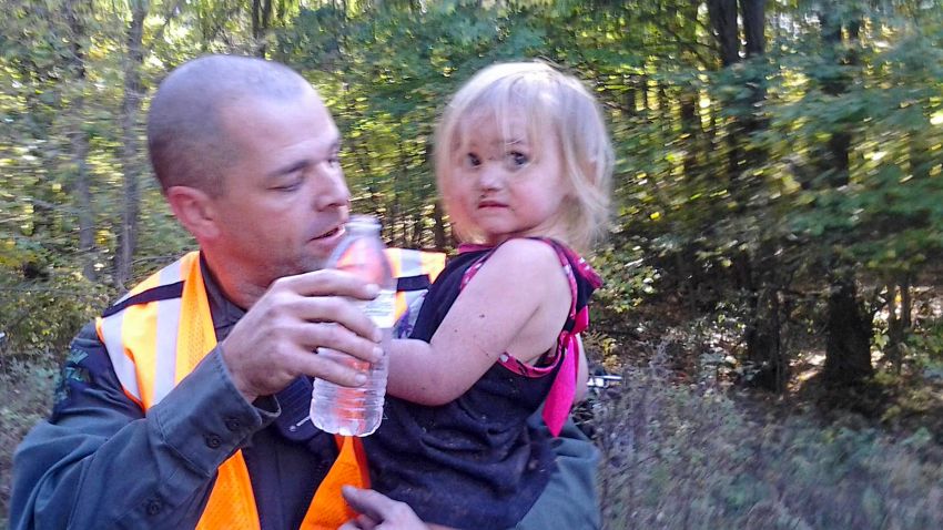 Michigan conservation officer Jeff Ginn holds Amber Smith, just after he located her in October 2013. Amber disappeared from her Barton Township home and Michigan Department of Natural Resources conservation officers were called in to assist with the search.
