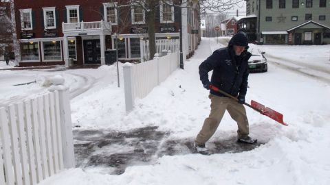 Bill Langley, of the Green Mountain Inn, in Stowe, Vermont, shovels snow from a sidewalk on Tuesday.