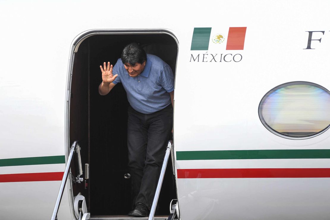 Morales waves upon landing in Mexico City.