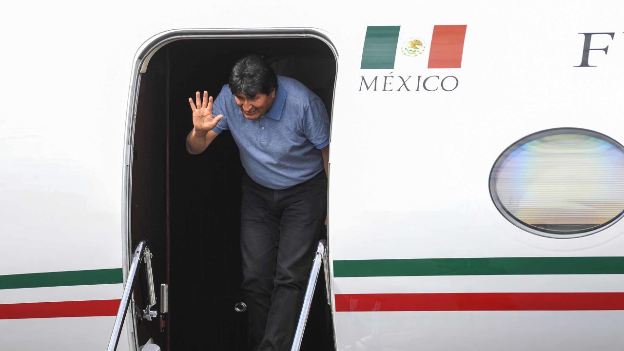 Morales waves upon landing in Mexico City.