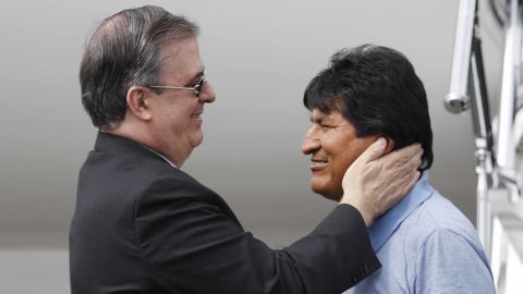 Mexican Foreign Minister Marcelo Ebrard, left, welcomes Morales upon his arrival in Mexico City.