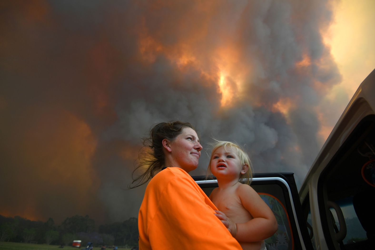 Residents look on as thick smoke rises from bushfires near Nana Glen on November 12.