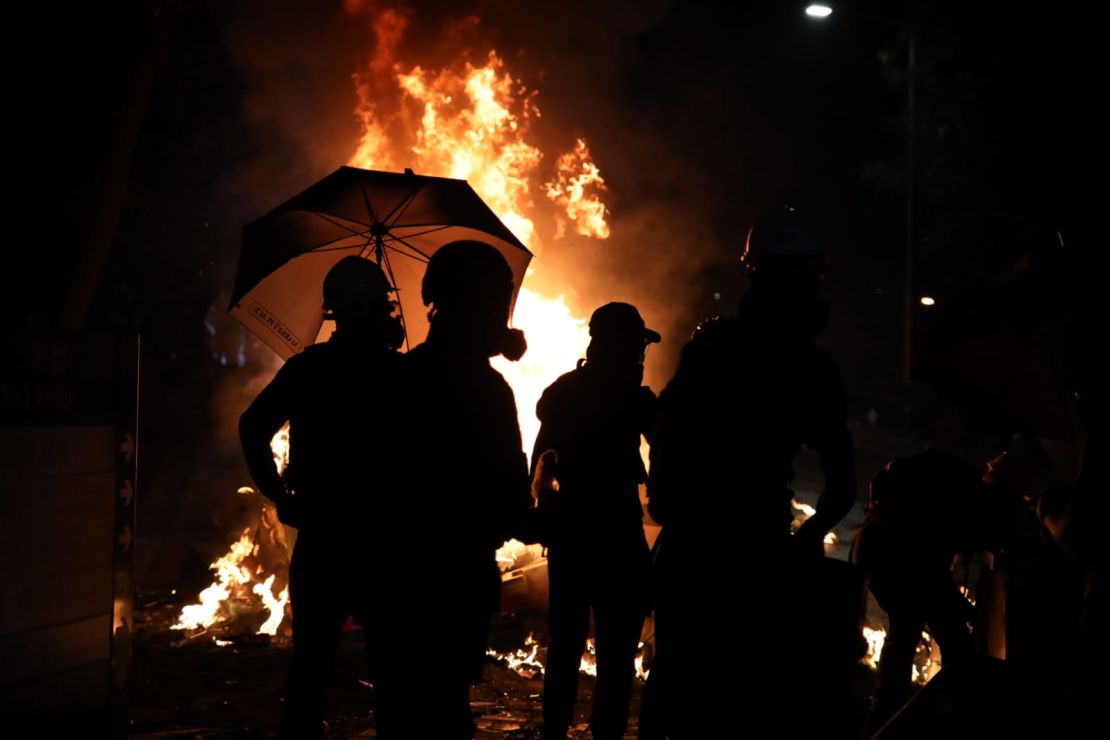 Protesters gather at the CUHK campus on Tuesday, November 12. Numerous fires were set and barricades thrown up to prevent police advance.