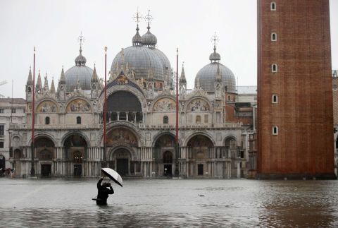A person photographs a flooded St. Mark's Square on November 12.