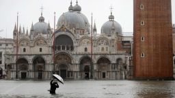 A person photographs flooded St. Mark's Square, in Venice, Italy, on Tuesday, November 12.