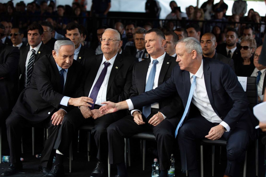 Benny Gantz (right) shakes hands with Prime Minister Benjamin Netanyahu as they attend a state memorial ceremony for former Israeli prime minister Yitzhak Rabin in Jerusalem on November 10, 2019.