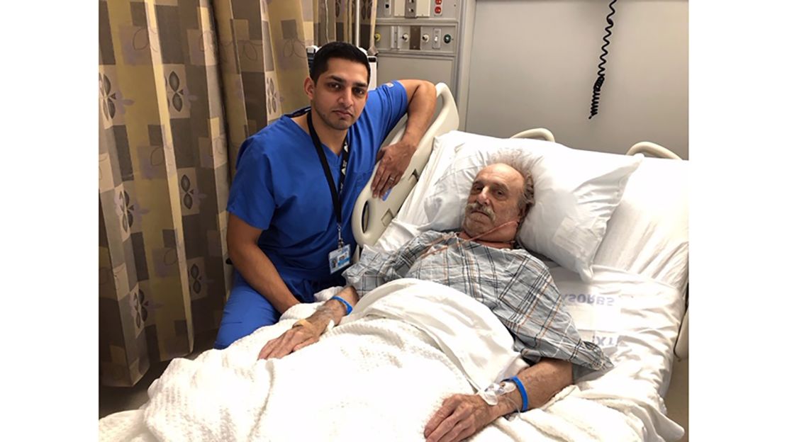 Dr. Nazir Khan and Milton Winger post for a photo after surgery.