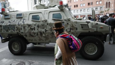 A military armored vehicle patrols as supporters of former President Morales march in La Paz.
