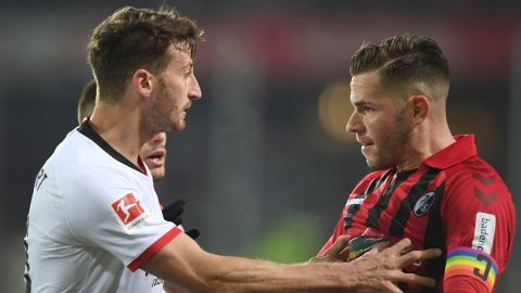 Abraham pushes Freiburg's defender Christian Guenter.