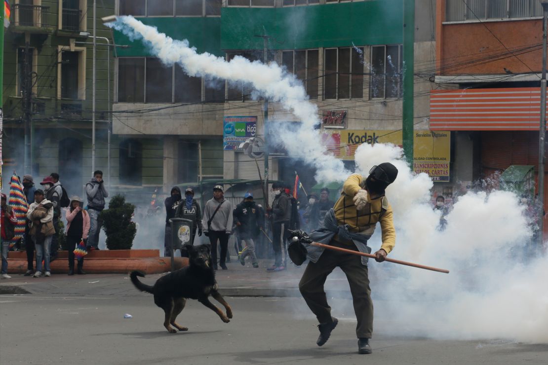 A demonstrator throws a smoking container during clashes with police in La Paz Wednesday.