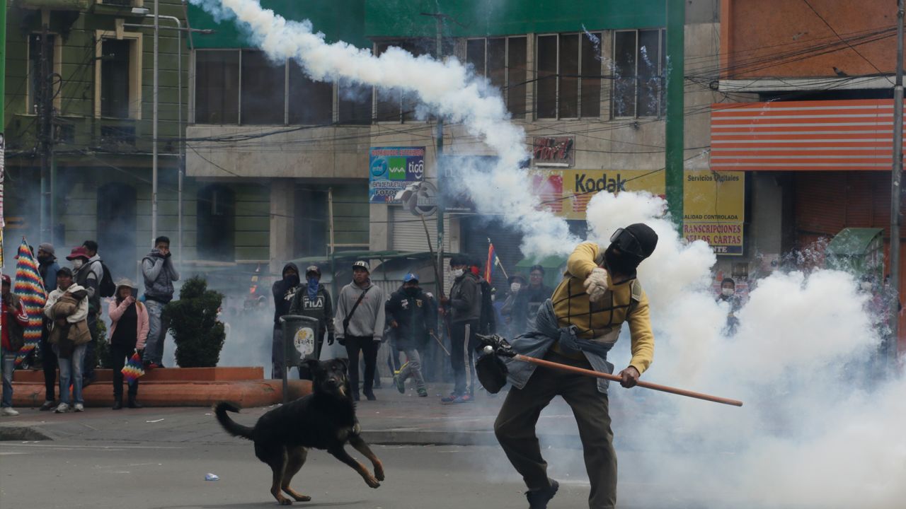 A demonstrator throws a smoking container during clashes with police in La Paz Wednesday.