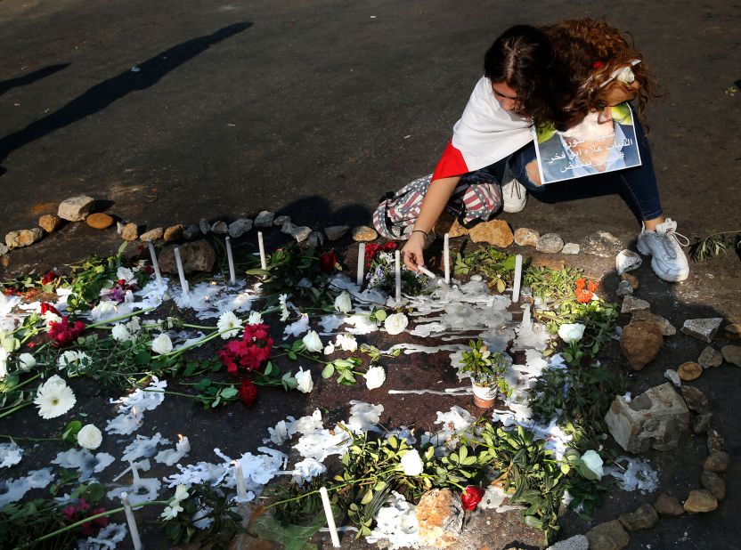 A mourner lights a candle at a makeshift memorial where Alaa Abu Fakher was killed by a Lebanese soldier during Tuesday night protests south of Beirut in Khaldeh neighborhood on November 13. Fakher was the first to be killed in direct shooting related to the protests, though there have been four other deaths since the demonstrations began.