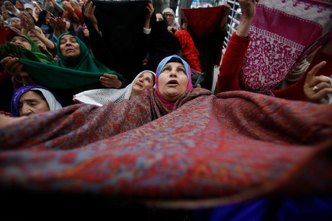 A Kashmiri Muslim woman raises her veil in the air to pray in Srinagar, India, on November 10, 2019.
