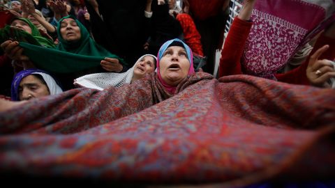 A Kashmiri Muslim woman raises her veil in the air to pray in Srinagar, India, on November 10, 2019. 