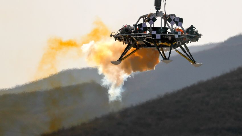 A lander is lifted during a test of hovering, obstacle avoidance and deceleration capabilities at a facility in Huailai in China's Hebei province, Thursday, Nov. 14, 2019. China has invited international observers to the test of its Mars lander as it pushes for inclusion in more global space projects. Thursday's test was conducted at a site outside Beijing simulating conditions on the Red Planet, where the pull of gravity is about one-third that of Earth. (AP Photo/Andy Wong)
