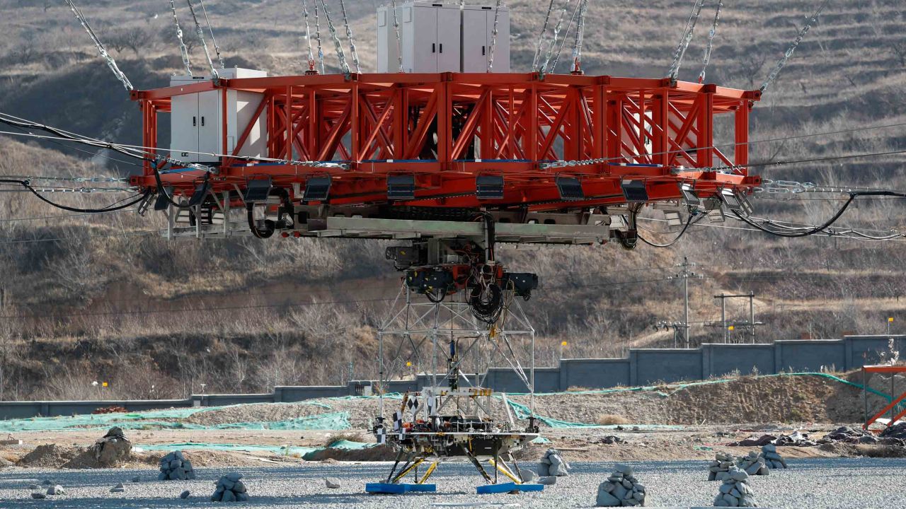 The lander sits before being lifted for tests of its hovering, obstacle avoidance and deceleration capabilities.