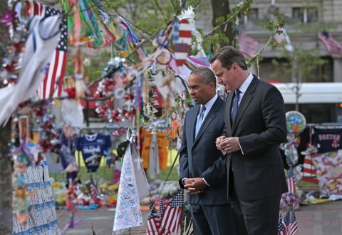 Patrick accompanies British Prime Minister David Cameron while visiting a memorial for the Boston Marathon bombing in May 2013.