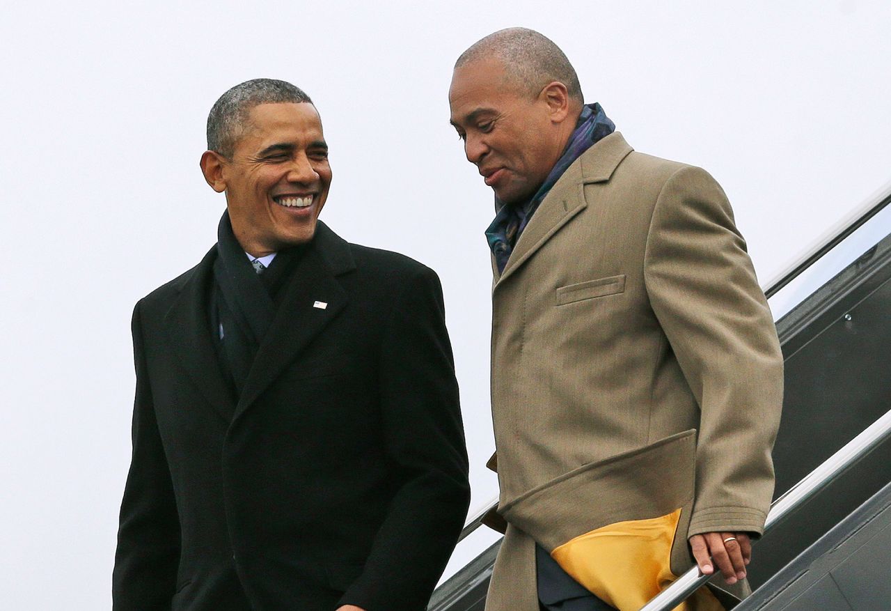 Patrick speaks with President Barack Obama after Air Force One arrived in Boston in March 2014. Patrick has been compared to Obama throughout his career, partly because both have leaned on their personal stories and ties to Chicago to rise to political power. They both also attended Harvard. They remain close to this day.