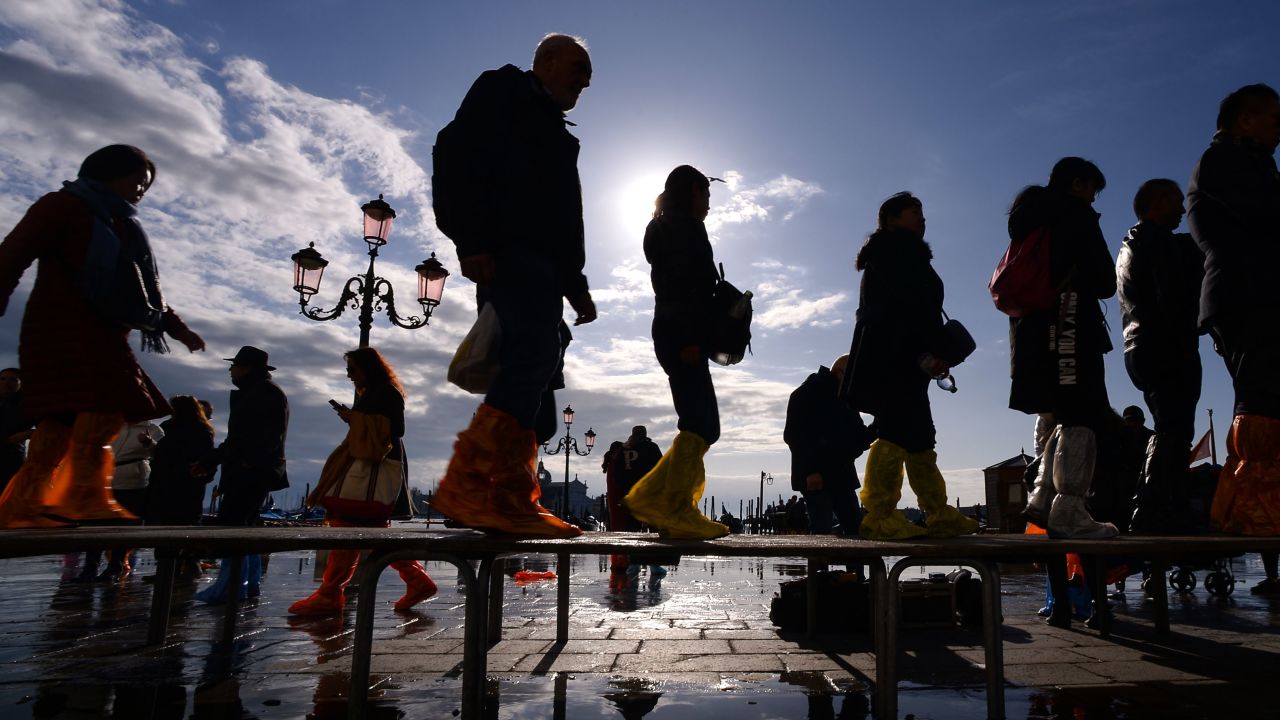 People walk across a footbridge on Riva degli Schiavoni on November 14, 2019 in Venice.