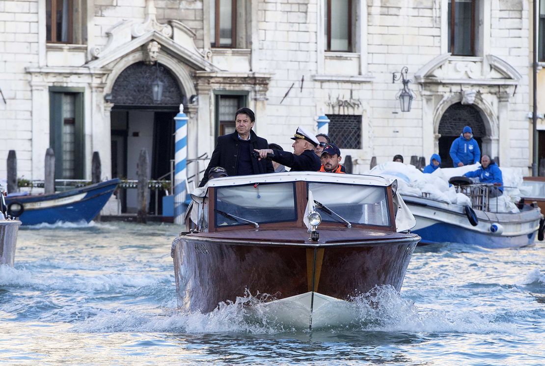 Italian Prime Minister Giuseppe Conte on a boat as he visits the flood-affected city of Venice on November 14, 2019.