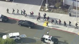   People are lead out of Saugus High School after reports of a shooting on Thursday, Nov. 14, 2019 in Santa Clarita, Calif.  The Los Angeles County Sheriff's Department says on Twitter that deputies are responding to the high school about 30 miles (48 kilometers) northwest of downtown Los Angeles. The sheriff's office says a male suspect in black clothing was seen at the school.  (KTTV-TV via AP)