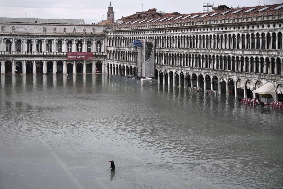 A general view shows a man crossing the flooded St. Mark's Square on November 13.