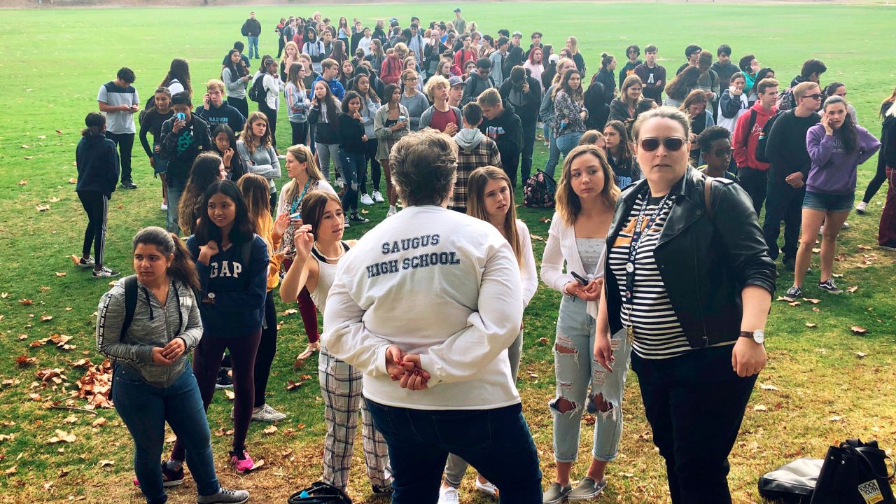 Students and others wait outside a reunification center in Santa Clarita.