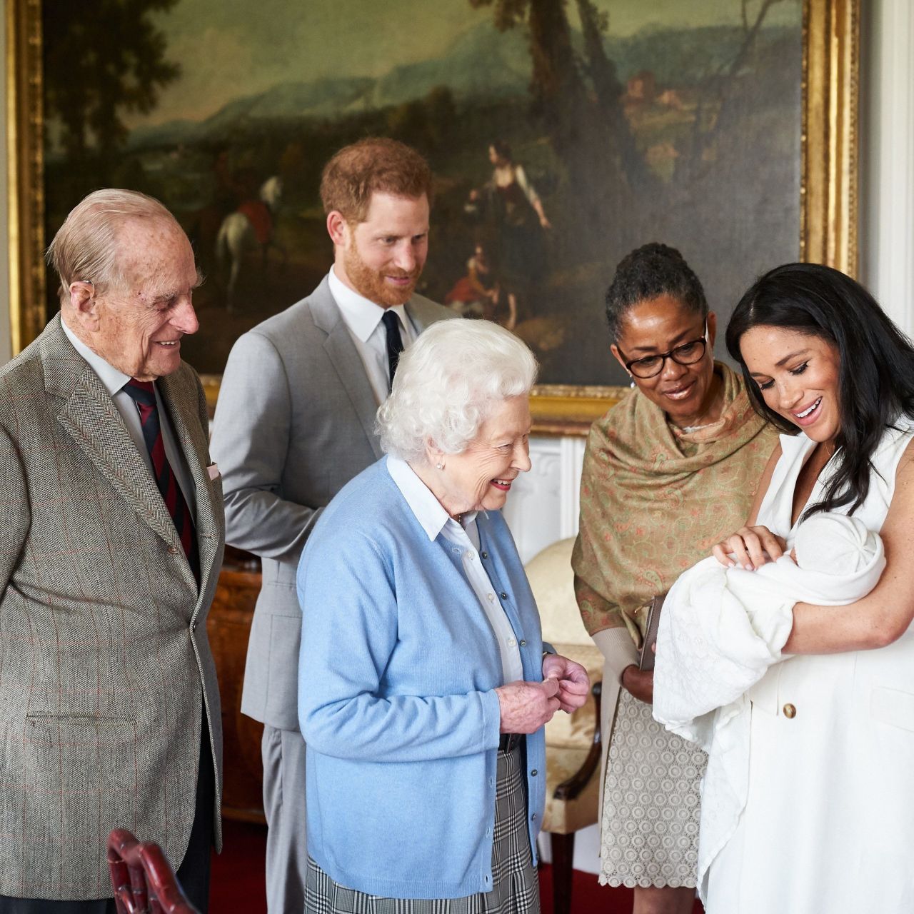 The Queen looks at <a href="http://www.cnn.com/2019/05/08/uk/gallery/archie-royal-baby-harry-meghan/index.html" target="_blank">her new great-grandchild, Archie,</a> in May 2019. Archie is the first child of Prince Harry, second from left, and his wife Meghan, the Duchess of Sussex. Prince Philip is on the far left. Meghan's mother, Doria Ragland, is next to her at right.