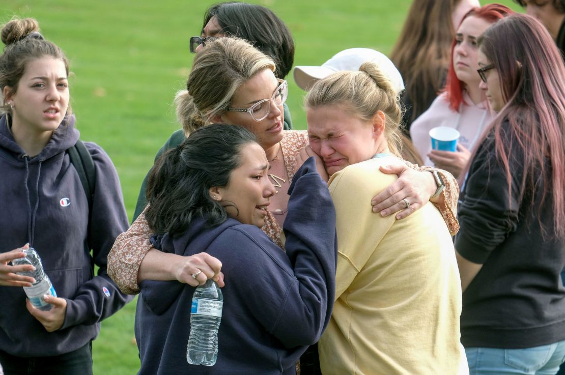 Students are comforted as they wait to be reunited with their parents following the shooting at Saugus High School.
