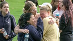 Students are comforted as they wait to be reunited with their parents following a shooting at Saugus High School that injured several people, Thursday, Nov. 14, 2019, in Santa Clarita, Calif. (AP Photo/Ringo H.W. Chiu)