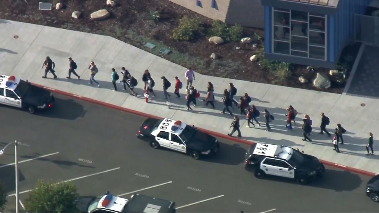 People are led out of Saugus High School after reports of the shooting.