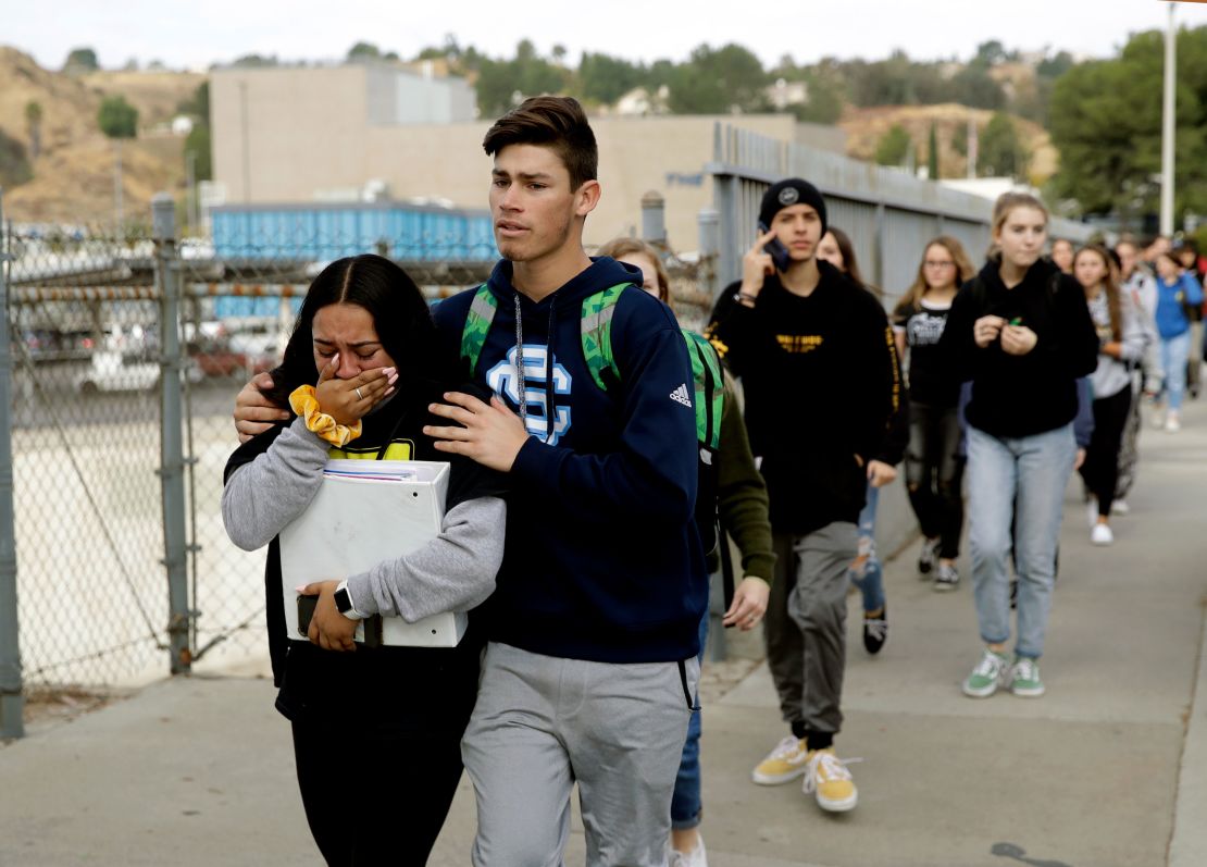 Students are escorted out of Saugus High School after the shooting Thursday.