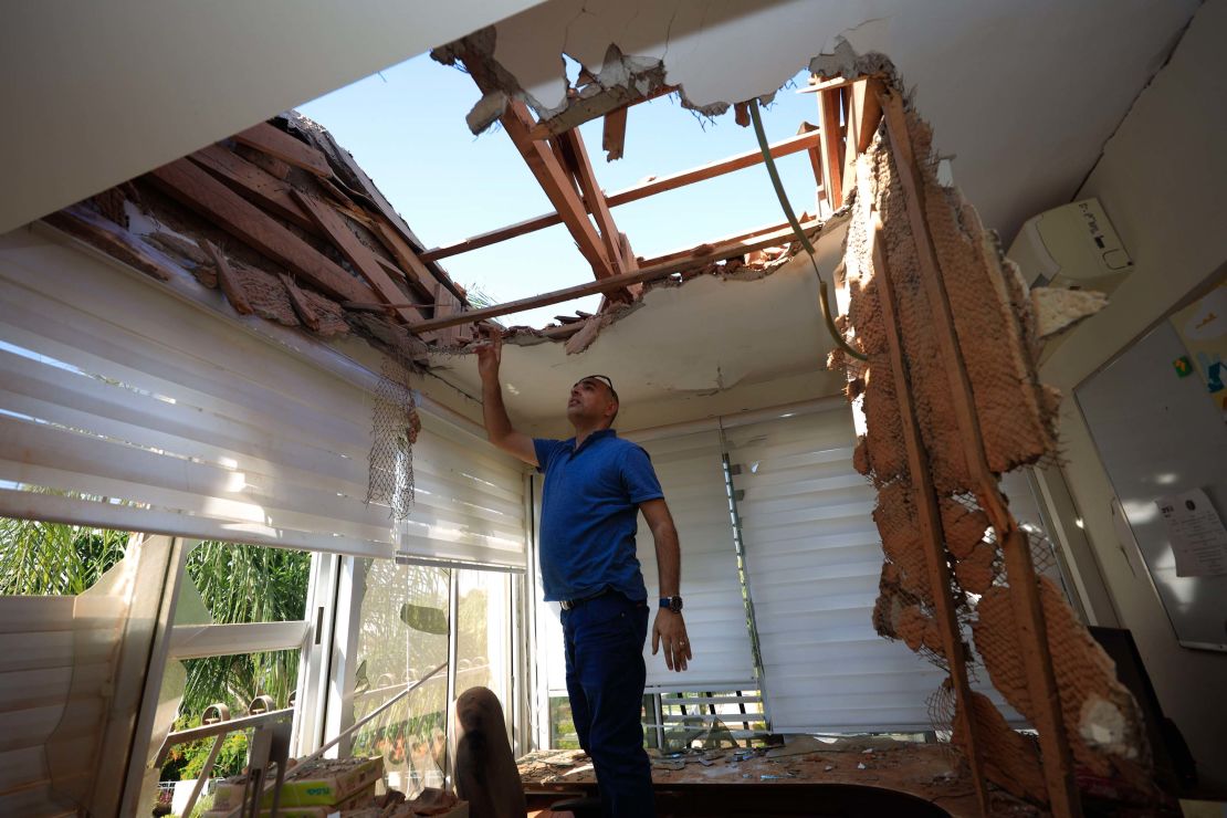 A man looks at the damage to a house in Sderot, Israel, after it was hit by a rocket fired from Gaza on Tuesday.