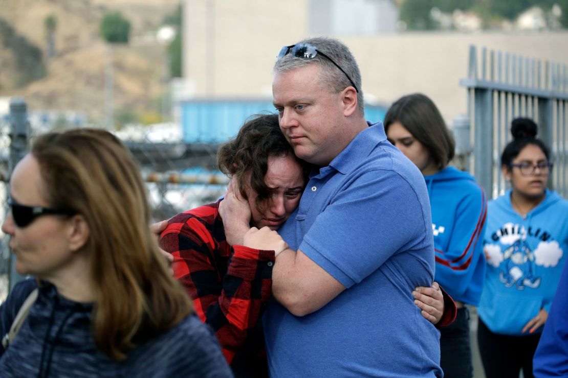 A parent and student embrace after the shooting at Saugus High School on Thursday.