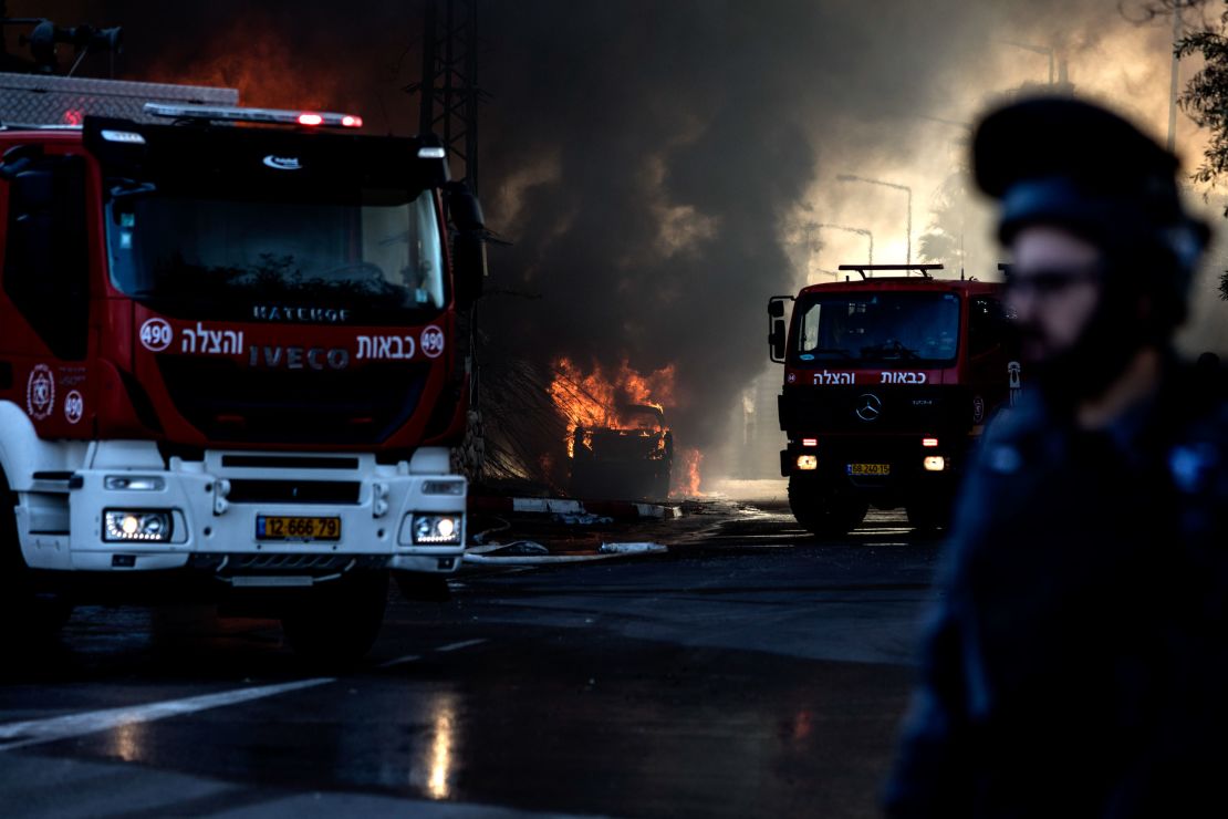 Firefighters at a factory that was hit by a rocket in Sderot, Israel on Tuesday.