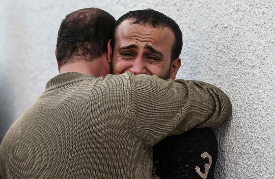 Palestinian men mourn outside the morgue of al-Shifa hospital in Gaza City on Wednesday.