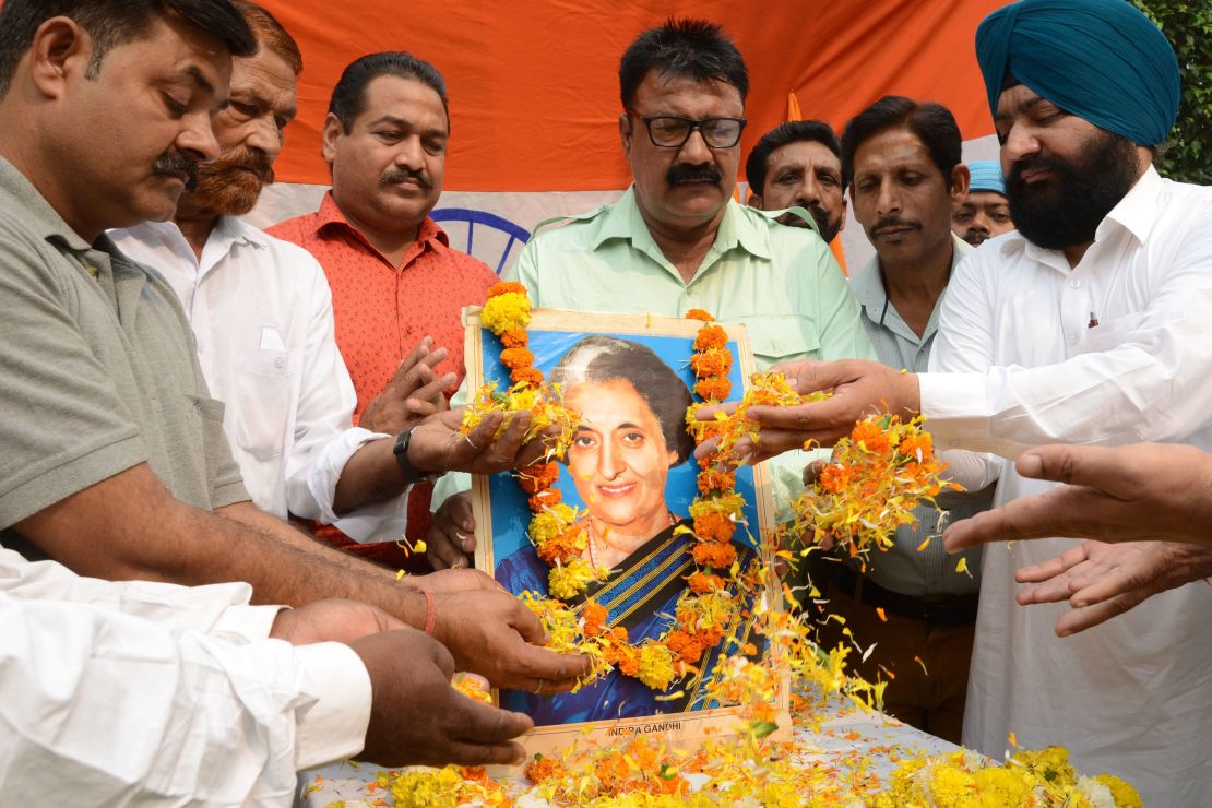 Men pay tribute to former Indian Prime Minister Indira Gandhi, in Amritsar on October 30, 2019.