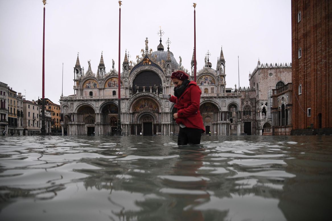 A woman crosses a flooded St. Mark's Square after an exceptionally high tide inundated Venice, Italy, on Tuesday, November 12. <a href="http://www.cnn.com/2019/11/13/world/gallery/venice-flooding-autumn-2019-intl/index.html" target="_blank">The flooding</a> is Venice's worst in 50 years.