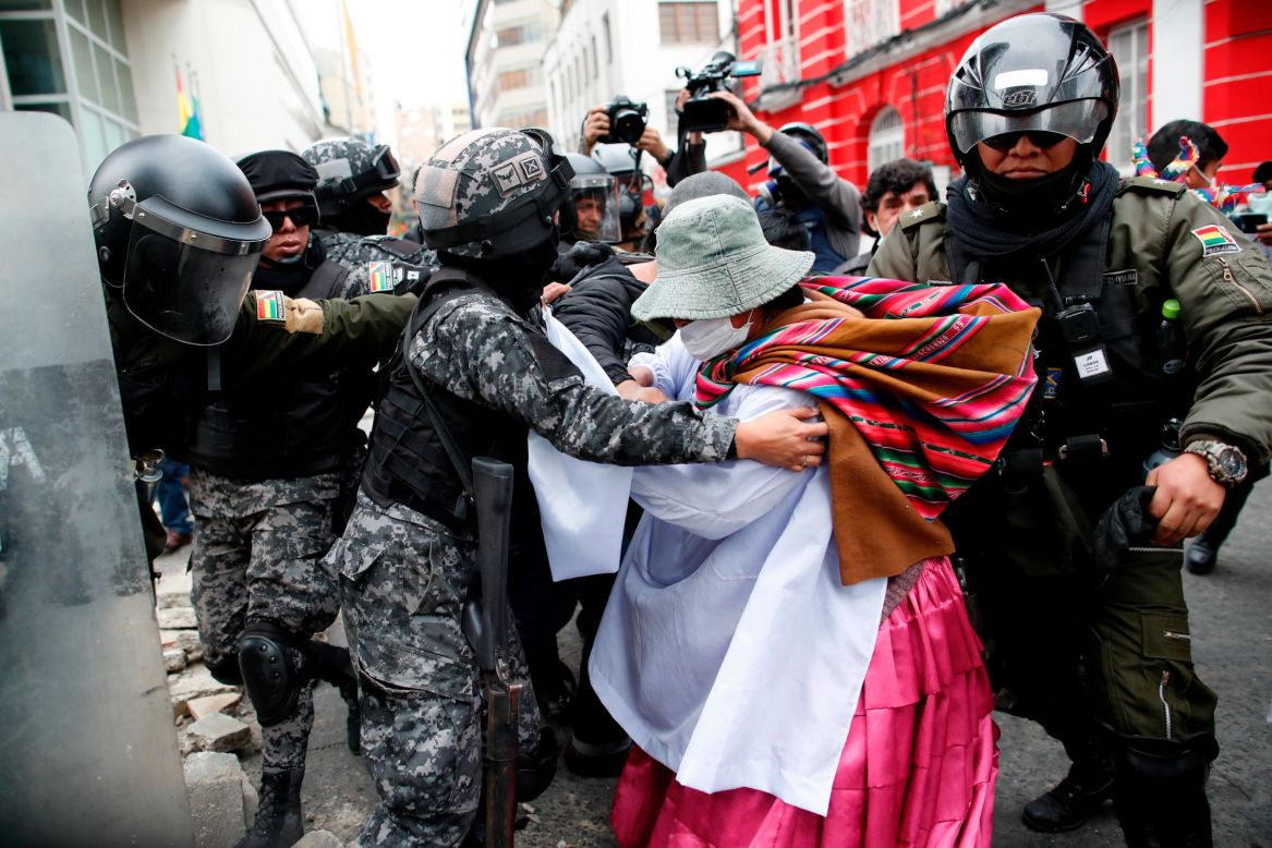 A supporter of former Bolivian President Evo Morales scuffles with police in La Paz, Bolivia, on Wednesday, November 13. <a href="https://www.cnn.com/2019/11/14/americas/bolivia-political-unrest-intl-hnk/index.html" target="_blank">Bolivia has been rocked by political unrest and mass protests</a> since electoral irregularities were reported in October. Morales and his political party were accused of rigging the vote, a charge he denies. Morales resigned from his post Sunday after nearly 14 years in power. He claims he is the victim of a coup orchestrated by right-wing politicians and the country's armed forces.