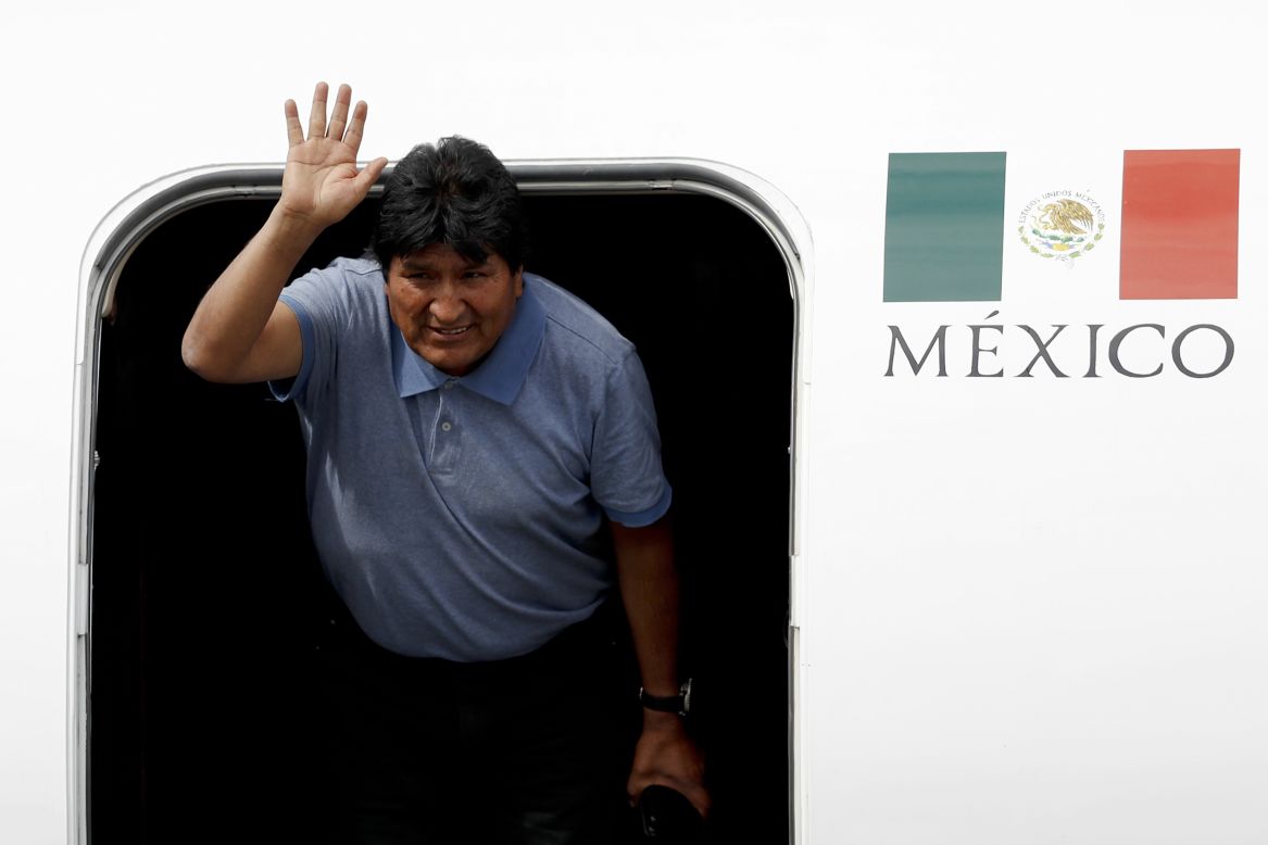 Former Bolivian President Evo Morales waves after arriving in Mexico City on Tuesday, November 12. Mexico granted asylum to Morales, who was in power for 14 years <a href="https://www.cnn.com/2019/11/14/americas/bolivia-political-unrest-intl-hnk/index.html" target="_blank">but resigned under mounting pressure.</a>