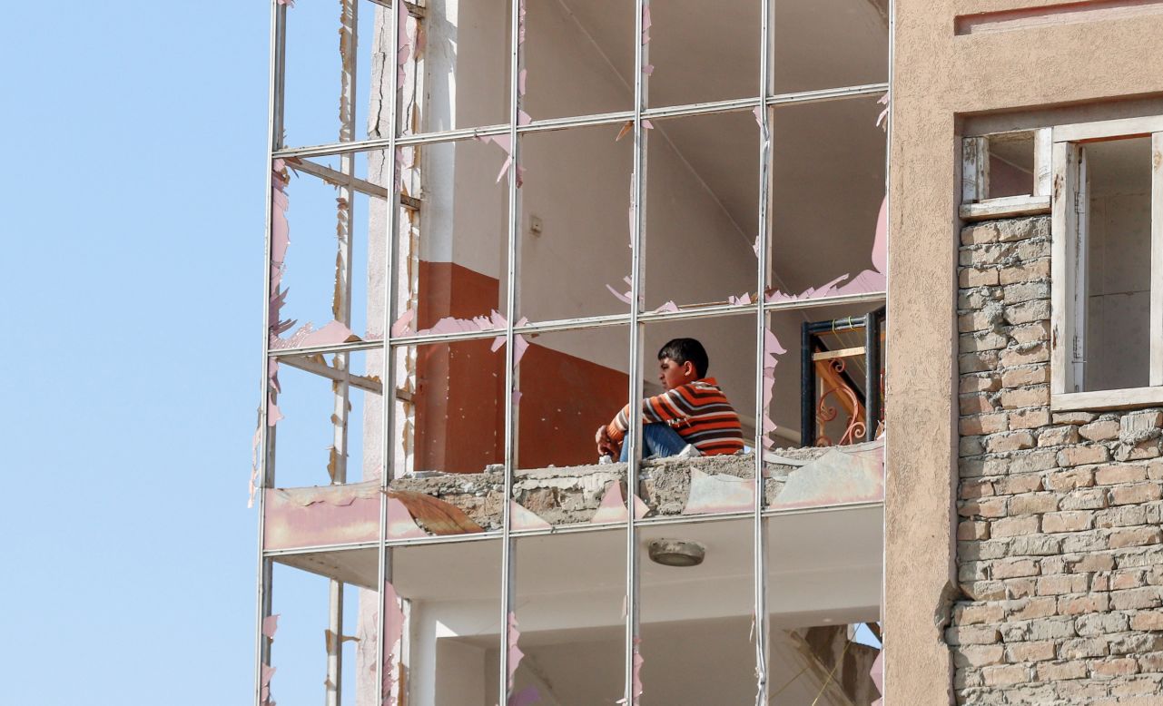 A child looks out from broken windows after a car bomb exploded in Kabul, Afghanistan, on Wednesday, November 13. <a href="https://apnews.com/74e7776b859f41b184eecf8c31df3c0b" target="_blank" target="_blank">Afghan officials said 12 people were killed.</a>
